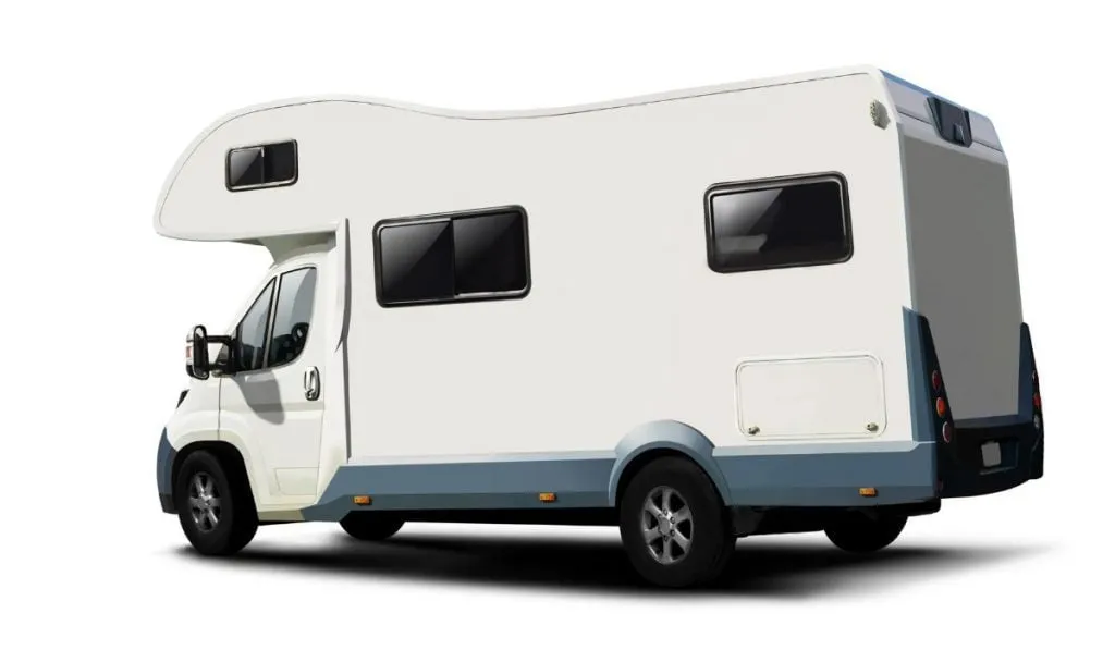 A white coachbuilt motorhome with an over-cab bed, photographed from the rear three-quarter angle against a plain background