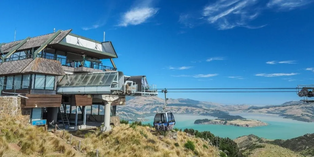 The Christchurch Gondola station on the Port Hills, with a cabin descending above the harbour below